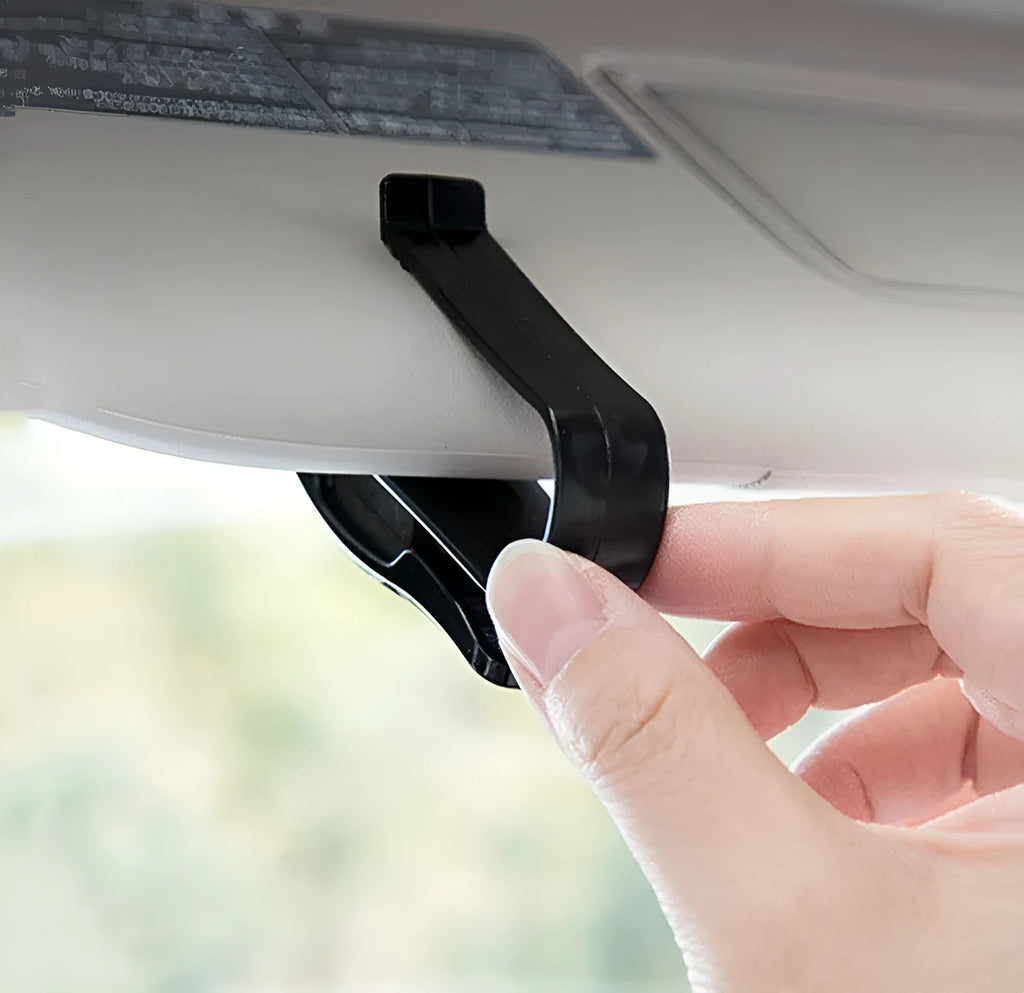 Black plastic car sun visor clip for holding glasses and cards, shown next to a ruler showing 6.5 cm length.