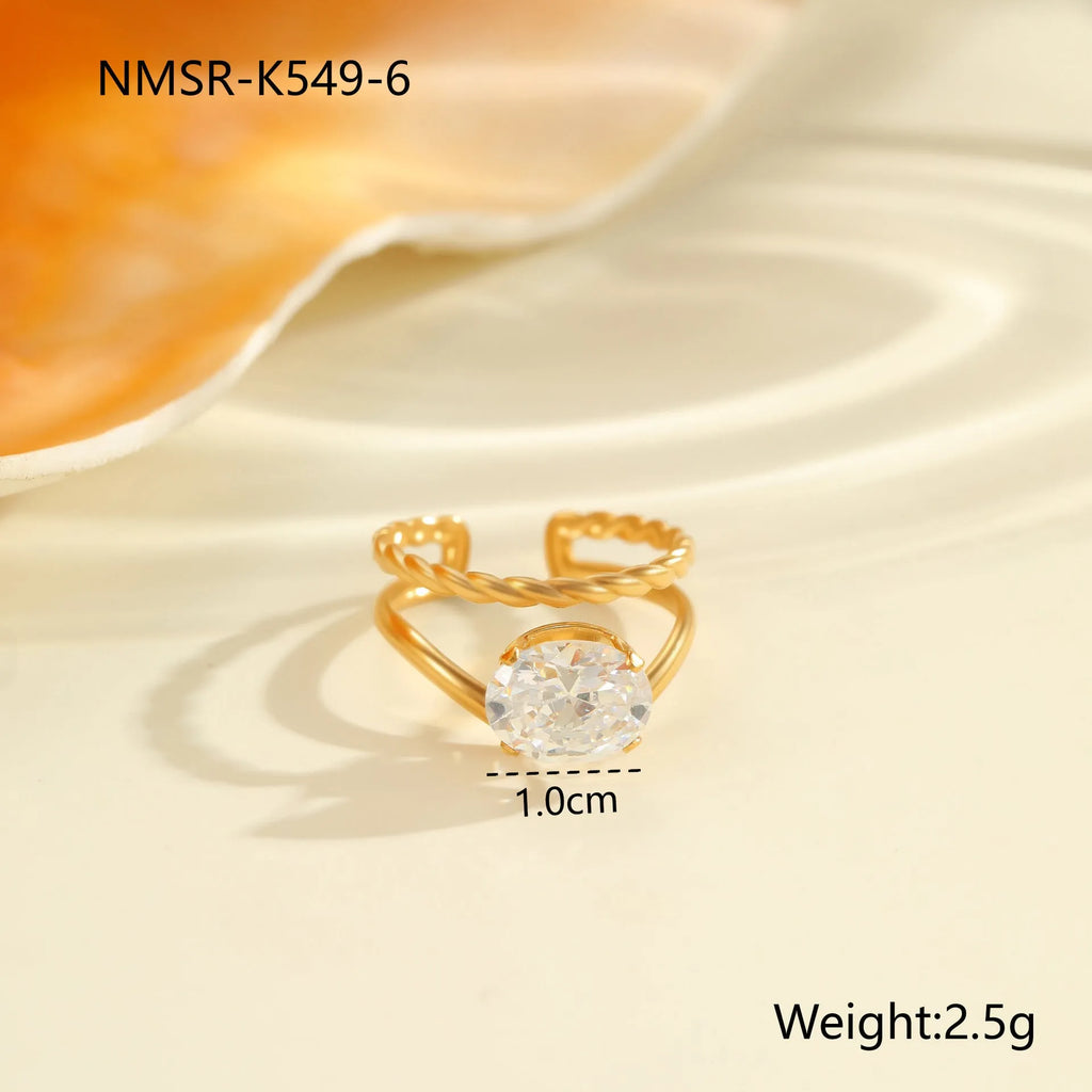 Gold-toned stainless steel ring with zircon details in a geometric heart shape design on a finger.