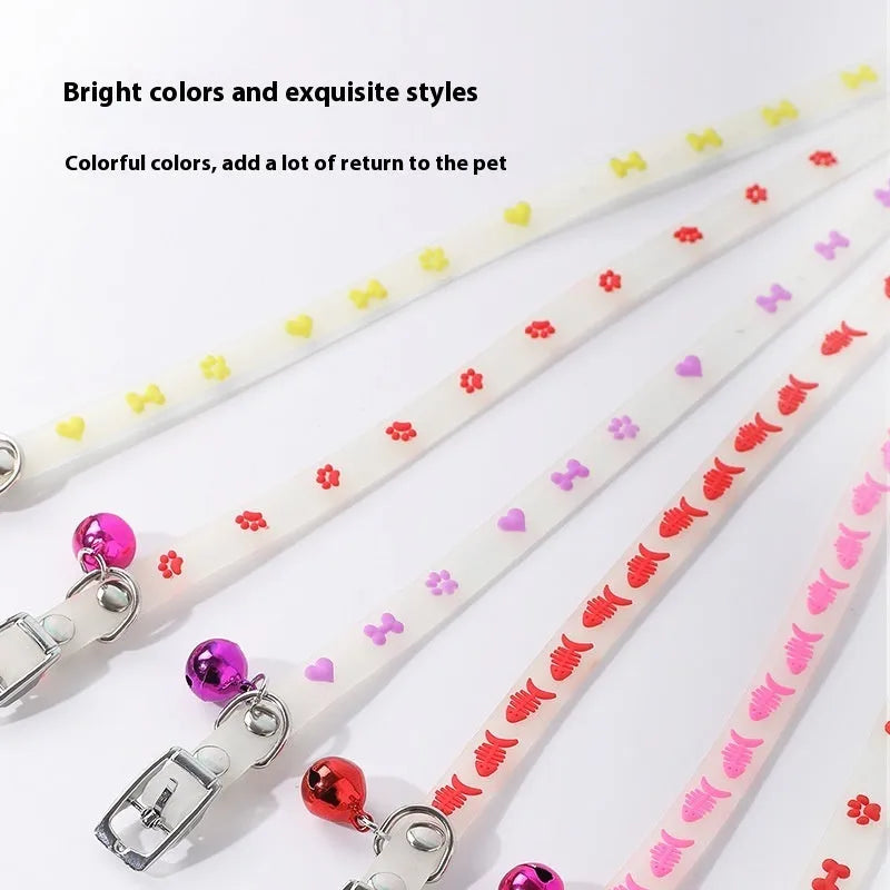 Glow in the dark adjustable silicone cat collar with metal bell in paw print pattern.