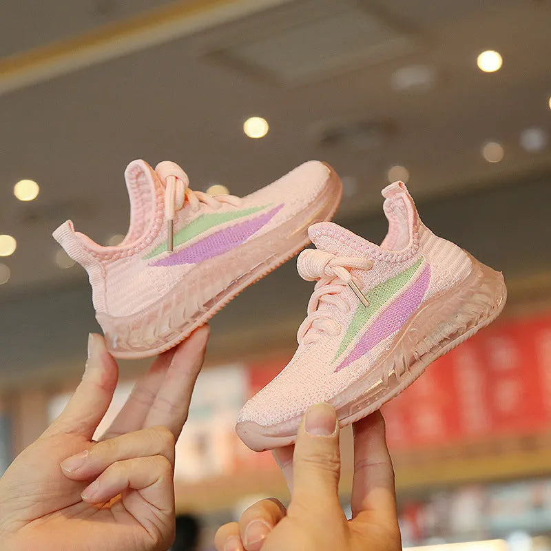 Children's white woven mesh sports shoes with rubber sole, side view on light background