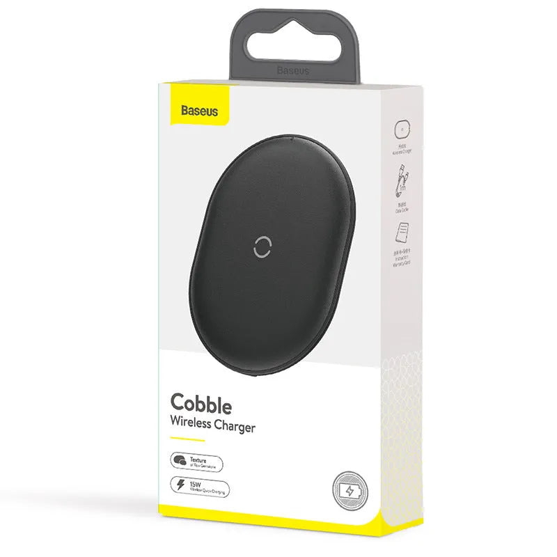Black Baseus wireless charging pad with a textured surface and a small LED light, next to a mobile phone.