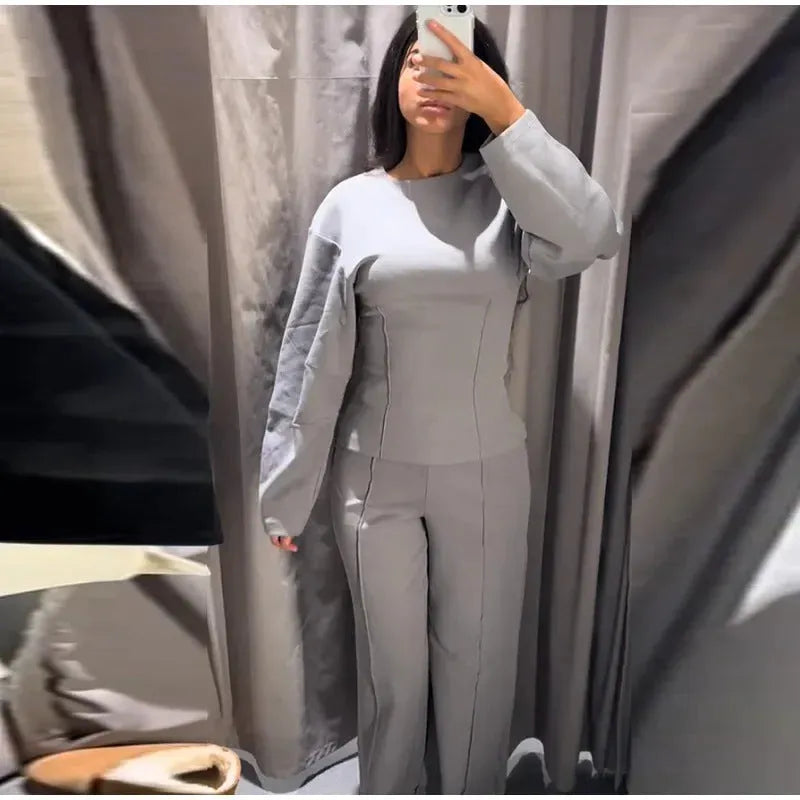 Women's black polyester fleece long sleeve top and wide leg pants two-piece suit set with pockets.