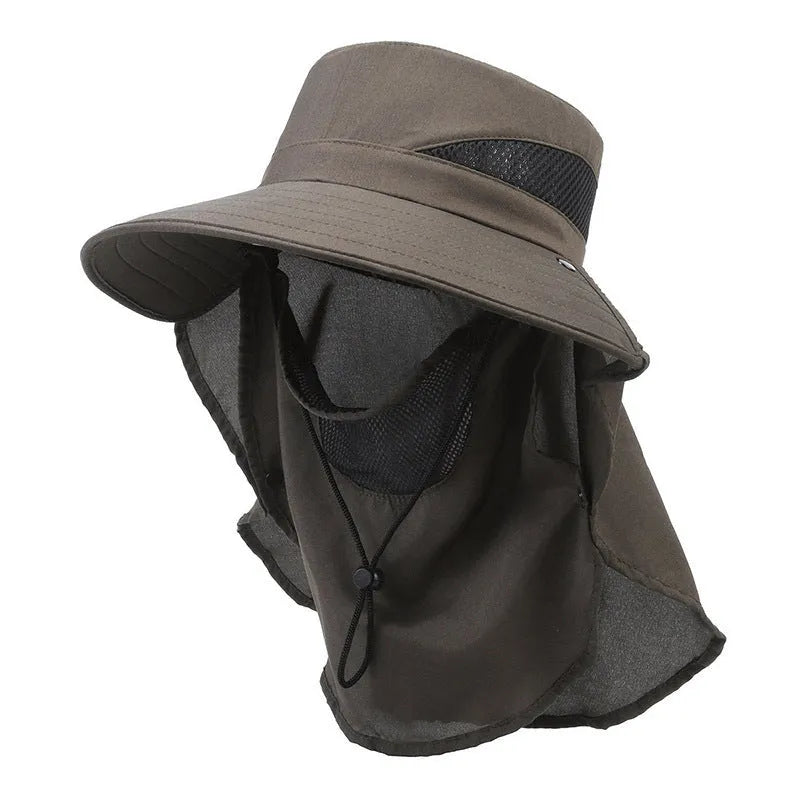 Man wearing a grey adjustable wide-brim fisherman hat made of polyester for sun protection.