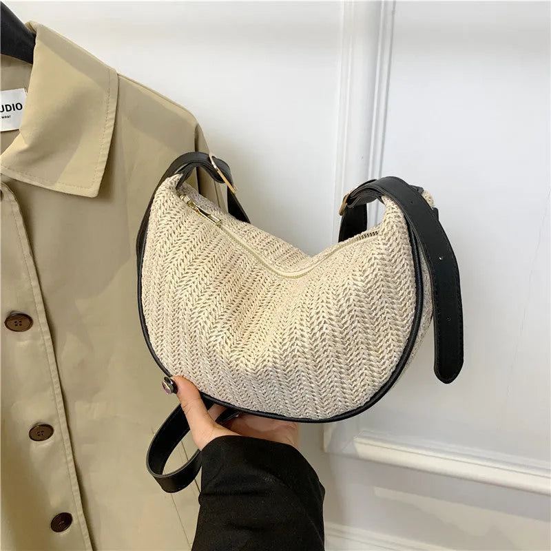 Women's woven straw crossbody bag with adjustable strap and interior organisation compartments
