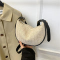 Women's woven straw crossbody bag with adjustable strap and interior organisation compartments