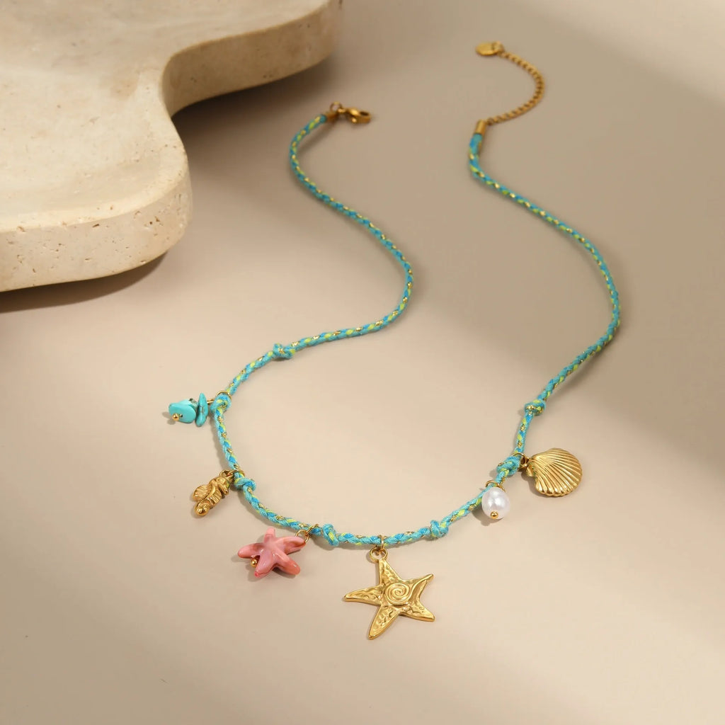 Braided rope chain stainless steel necklace with heart pendant and 18K gold plating on a model.