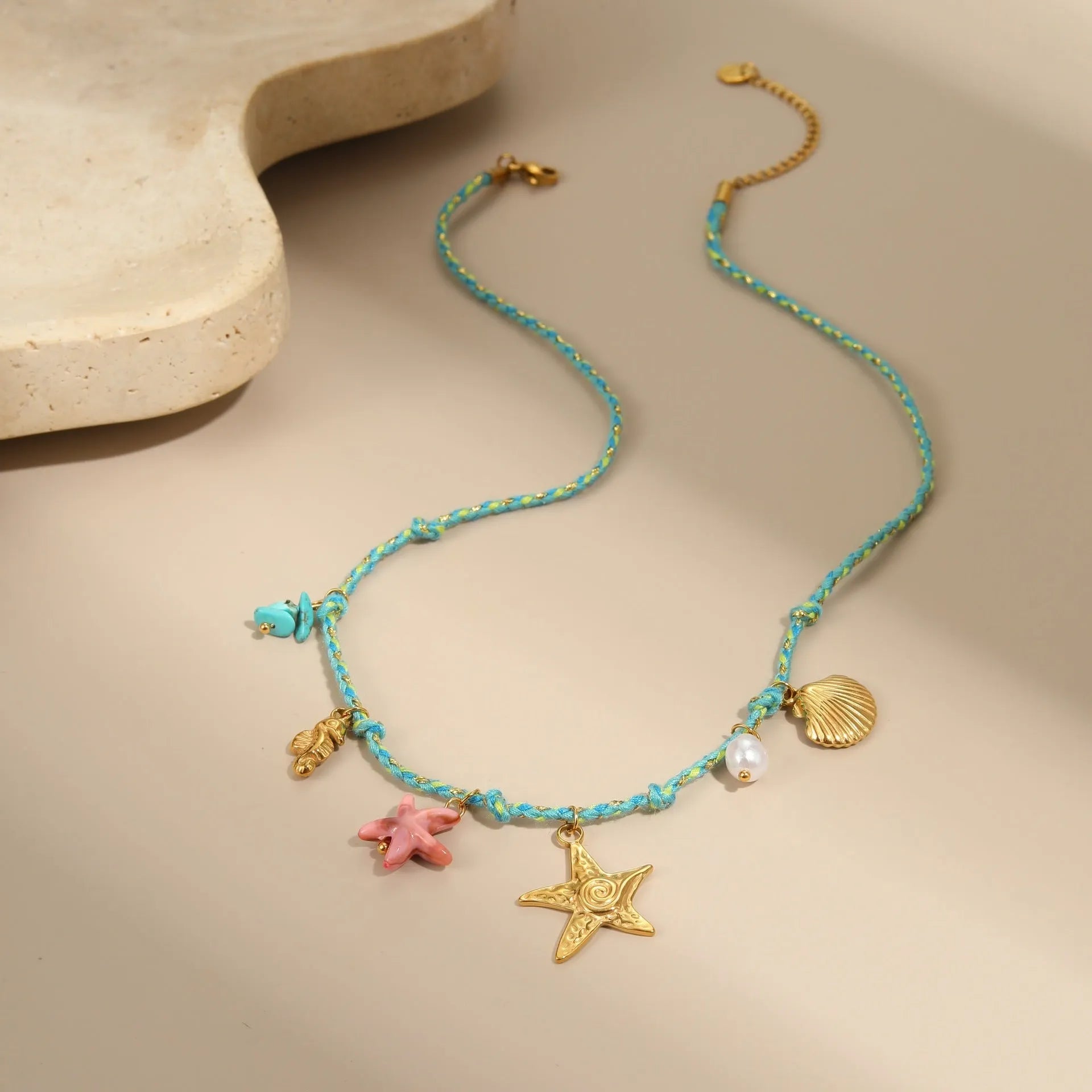 Braided rope chain stainless steel necklace with heart pendant and 18K gold plating on a model.