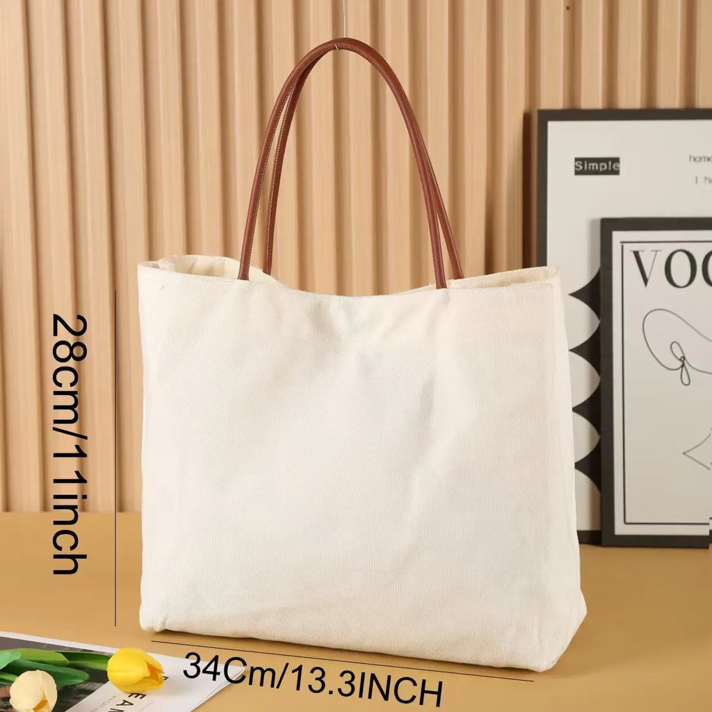Beige white canvas tote bag with zip closure showing its spacious interior