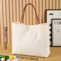 Beige white canvas tote bag with zip closure showing its spacious interior