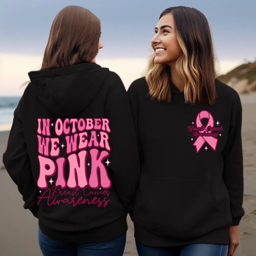 Women's pink breast cancer awareness pullover hoodie with a retro graphic design and side seam pockets.