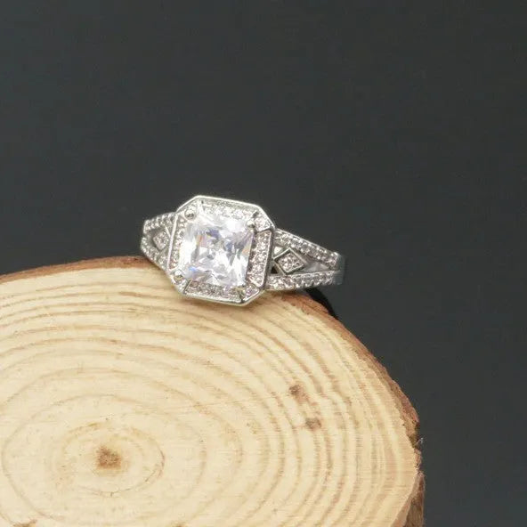 Women's geometric zircon ring with hollow design and quadrilateral shape in platinum colour.