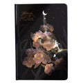 A5 notebook with luminous reflective cover shown in four colours: deep blue, gold, light blue, purple, open to reveal pages with colour illustrations.