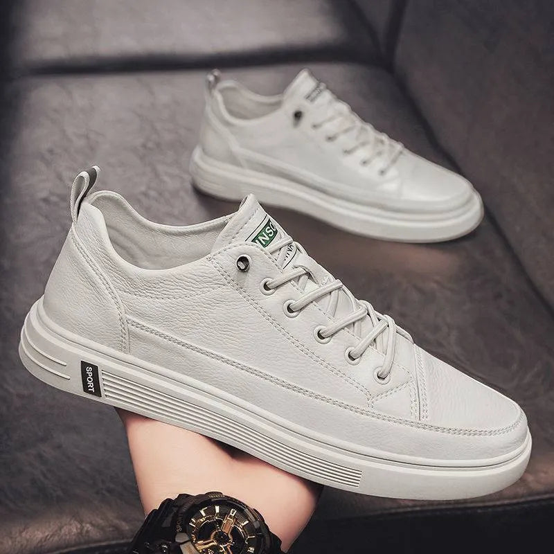 Men's white PU leather casual sneakers with a flat bottom and low heel on a plain background