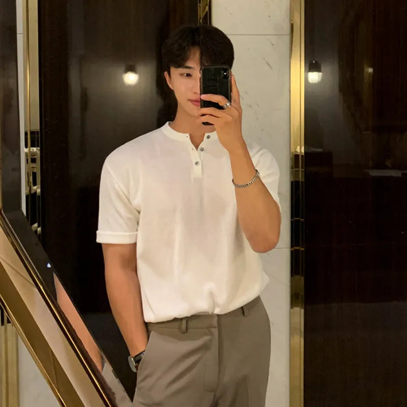 Man wearing a thin black slim-fit knitted short-sleeved pullover shirt.