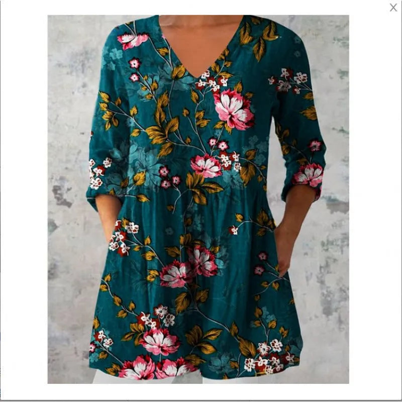 A woman wearing a loose, printed dress with 3/4 sleeves and a wide waist, available in multiple sizes.