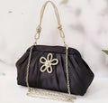Women's soft polyester shoulder messenger bag in shell shape with diamond folds and chain detail.