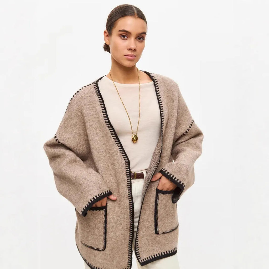 Loose lace-up front knitted cardigan in camel colour, showing mid-length fit and long sleeves.