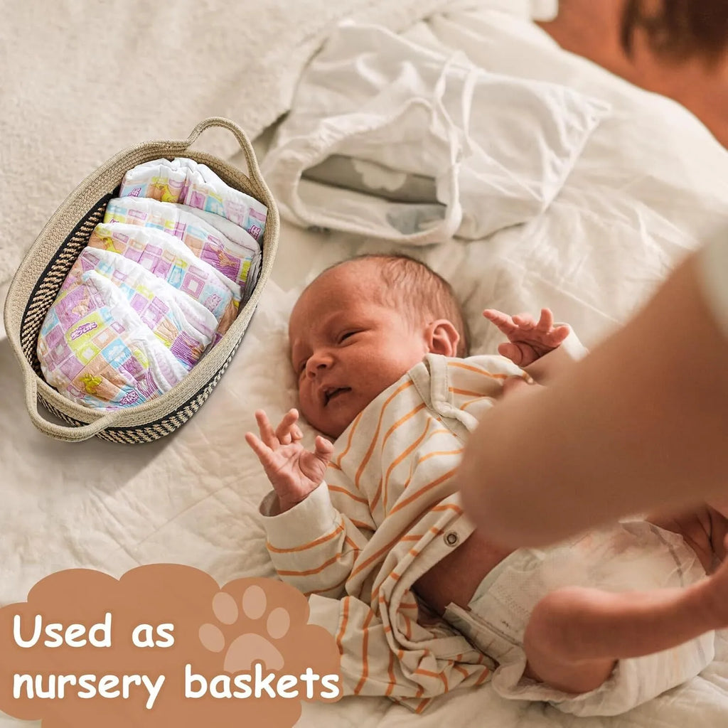 Handmade light beige woven cotton rope storage basket with a handle, shown on a wooden surface.