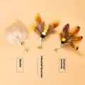 Three steel wire cat toy replacement heads shaped like small flying insects in assorted colours.