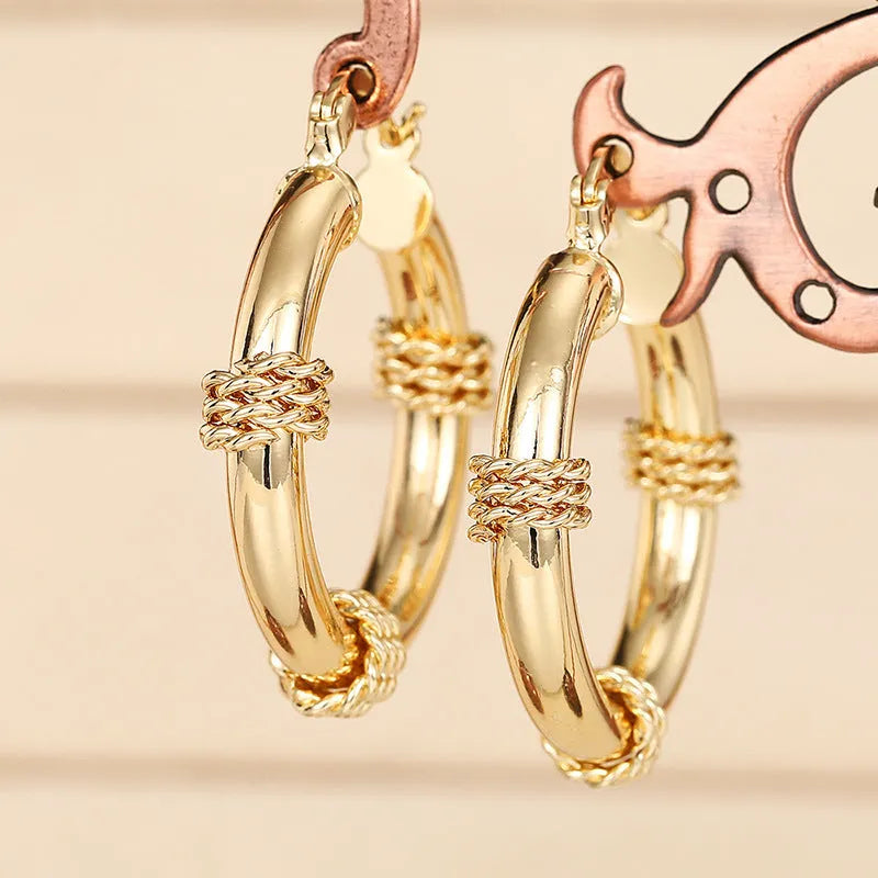 Geometric copper earrings in golden colours with ring and line elements for women