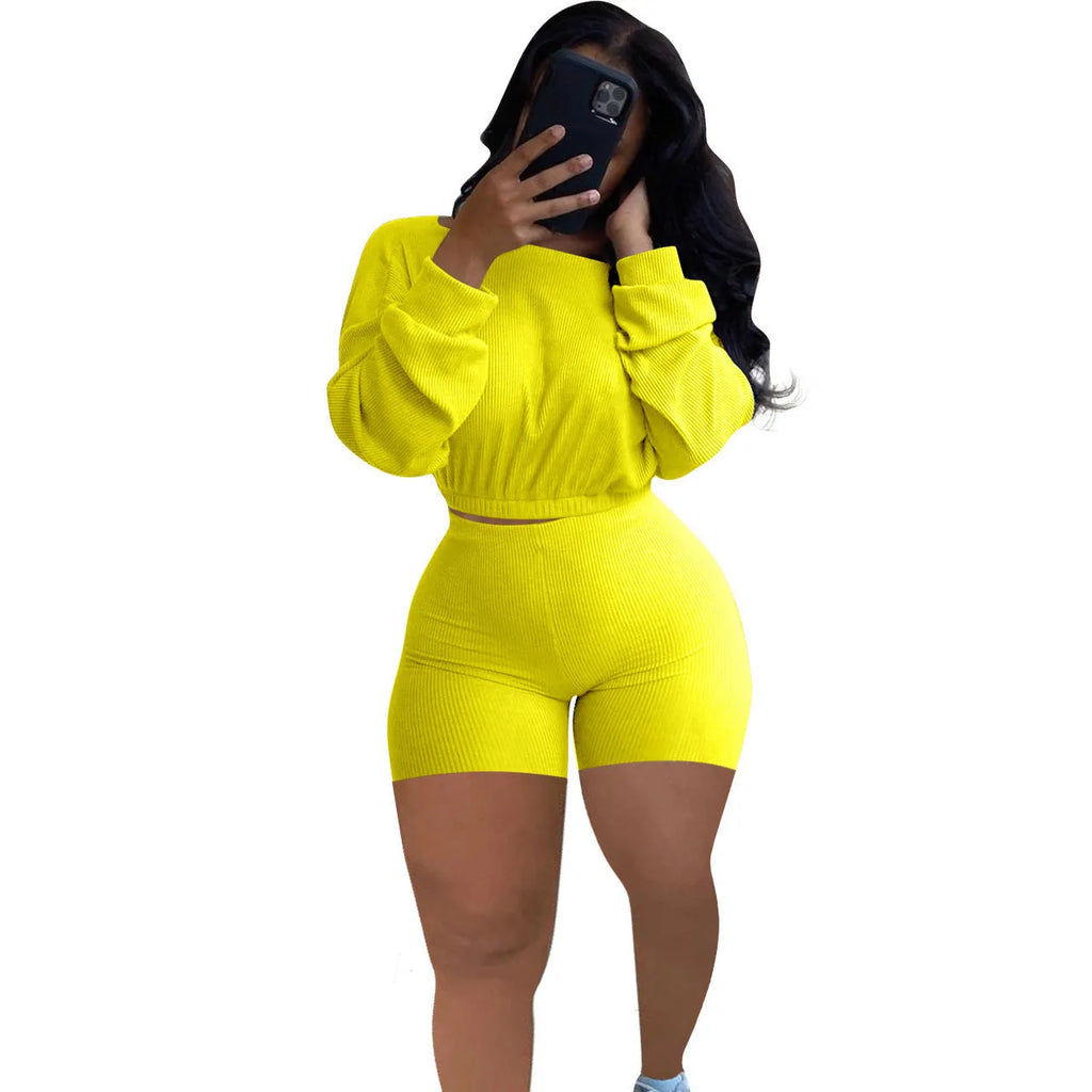 Women's off-the-shoulder long sleeve top and shorts two-piece set in a solid colour.