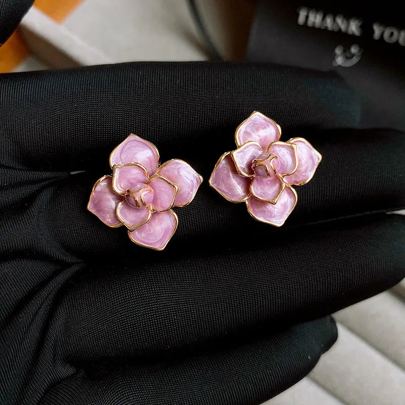Purple flower stud earrings with gold plating and oil-spot glaze finish on copper construction