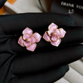 Purple flower stud earrings with gold plating and oil-spot glaze finish on copper construction