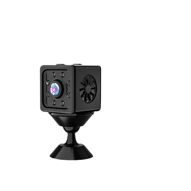 Black cubic Remote Network K13 Sports Camera on a table with its mounting bracket and data cable.
