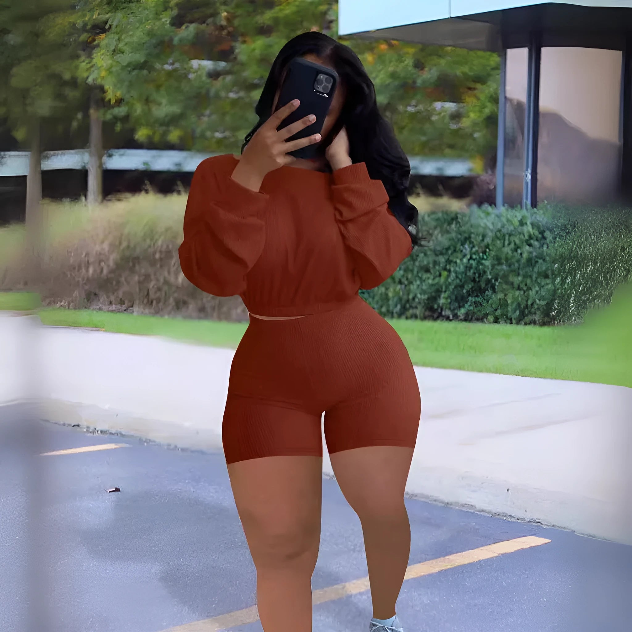 Women's off-the-shoulder long sleeve top and shorts two-piece set in a solid colour.