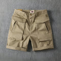Men's army green cotton cargo shorts with multiple pockets and a straight leg design.