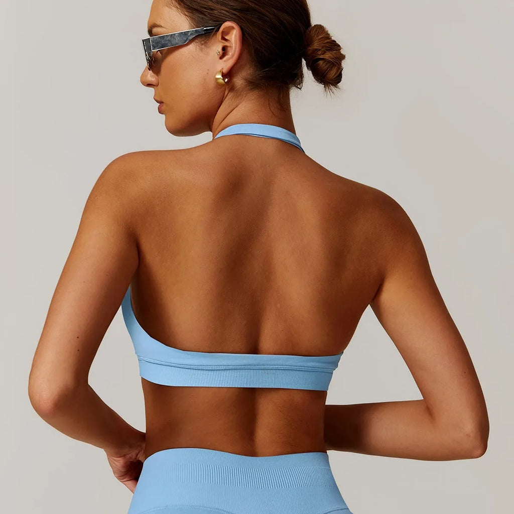 Women's black halter-neck sports bra for yoga and workouts with chest pads.