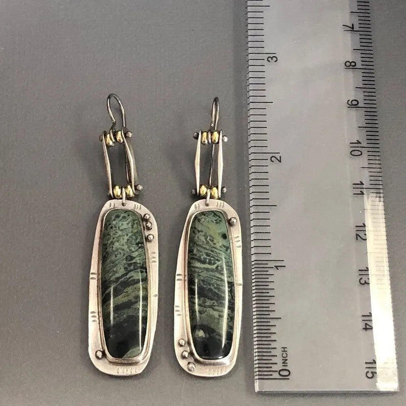 Geometric two-colour marble pattern alloy earrings on a white background.
