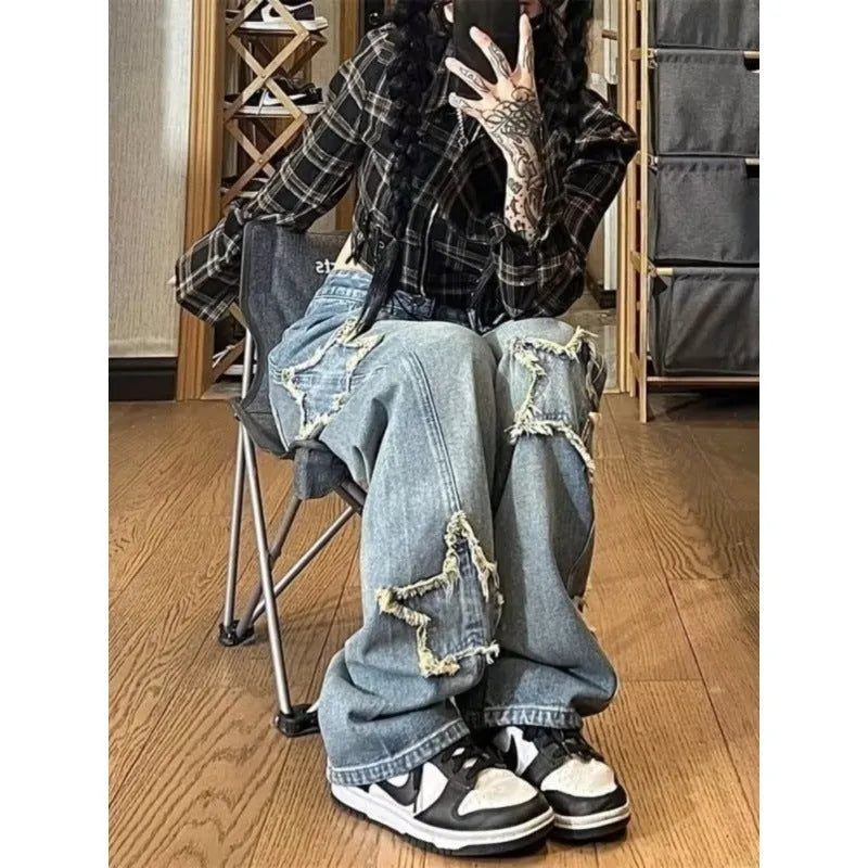 Blue high waist wide-leg denim trousers on a hanger, showing straight leg cut.