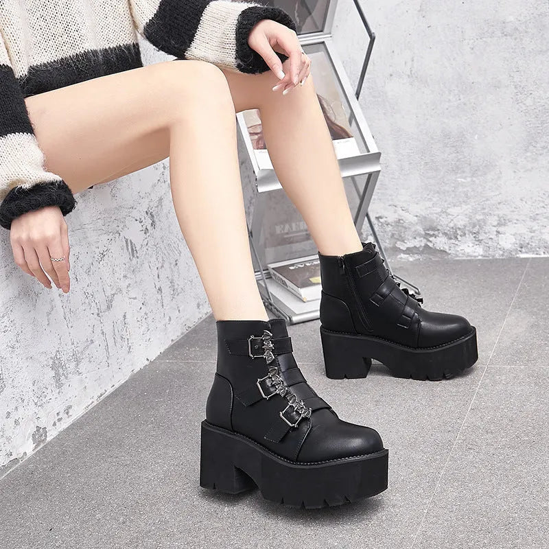 Black women's punk boots with bat buckle, side zip, thick heel, and round toe.