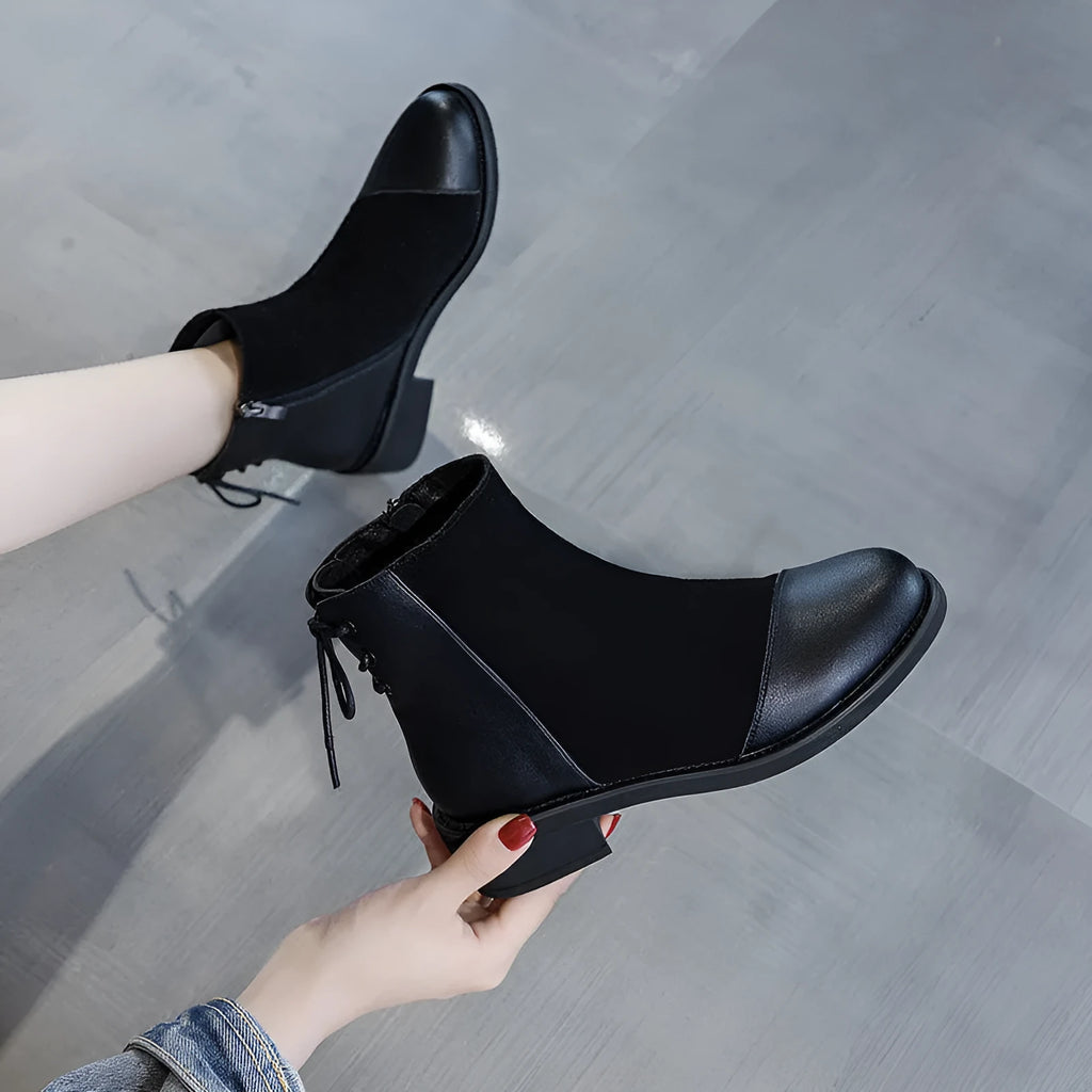 Women's black Martin boots with side zipper, round toe, and decorative bow detail