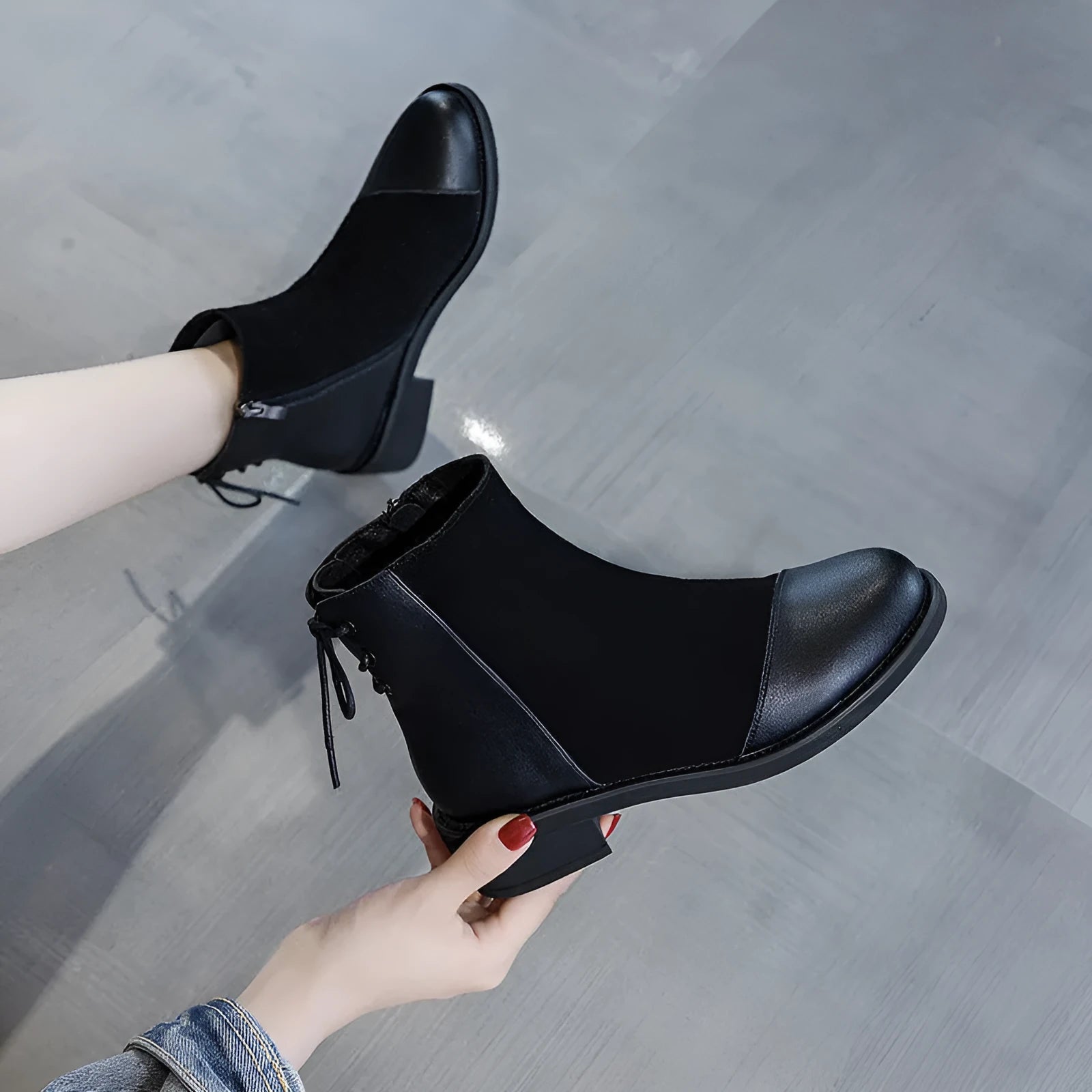 Women's black Martin boots with side zipper, round toe, and decorative bow detail