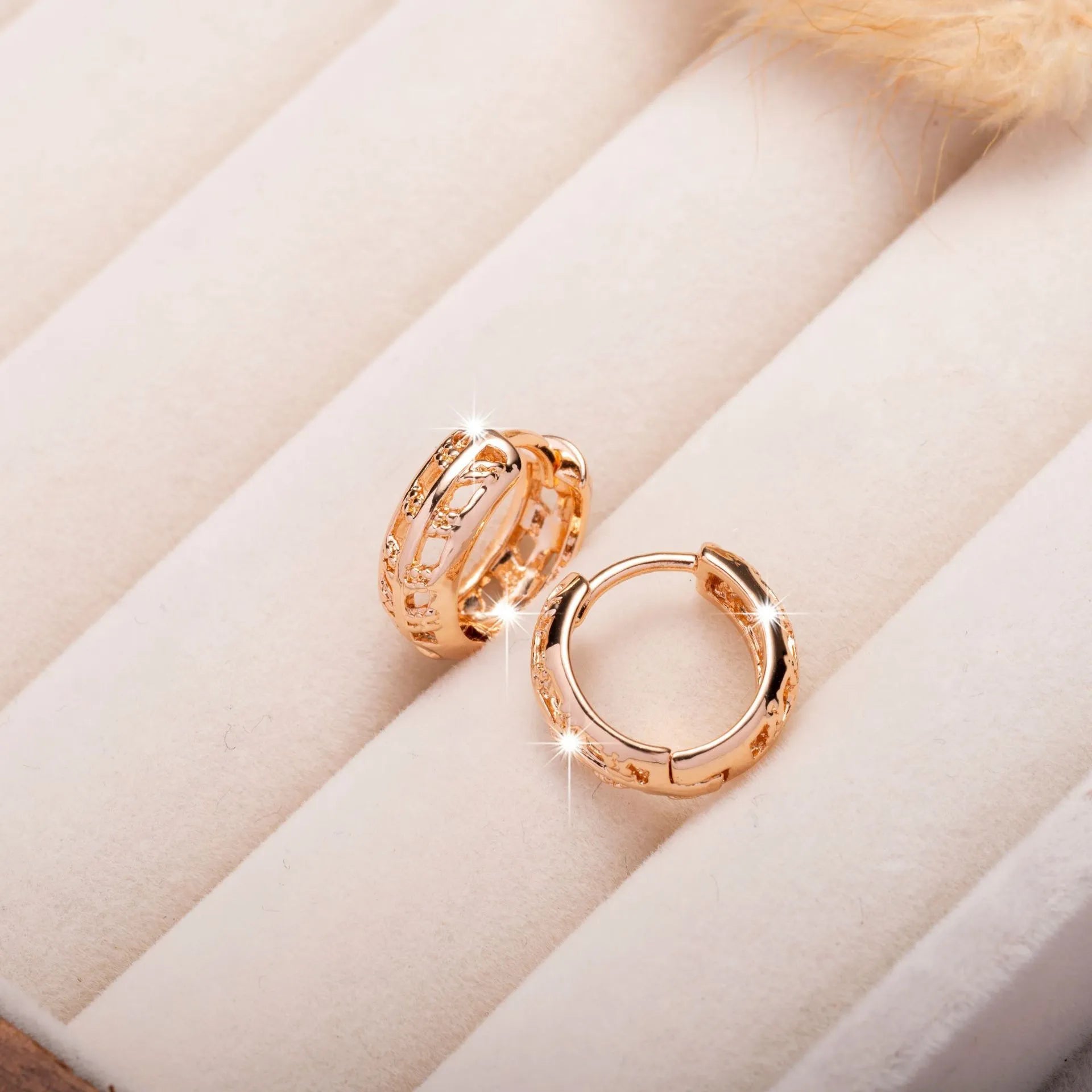 Hollowed-out copper earrings in heart and leaf shapes with a rose gold finish.