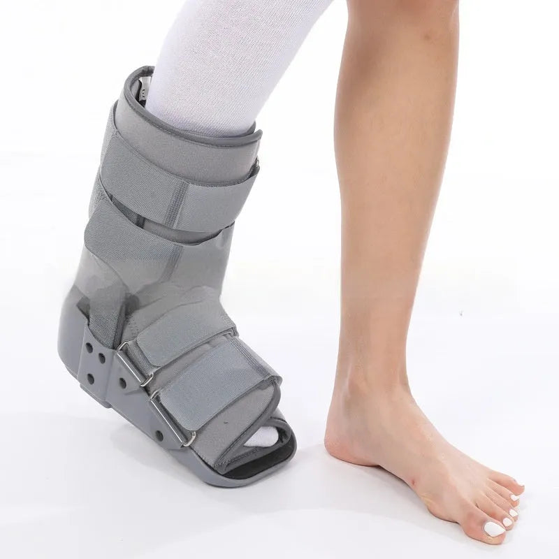 Grey and black Achilles tendon rehabilitation boot with plastic shell, adjustable straps, and rubber sole.