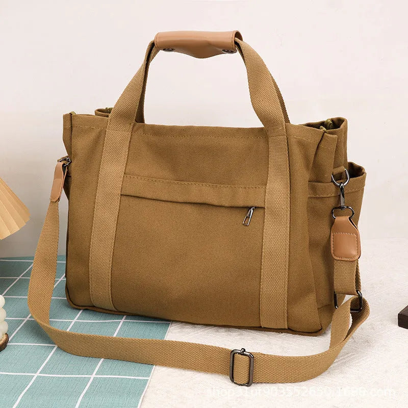 Large canvas tote bag with multiple internal compartments in horizontal square design