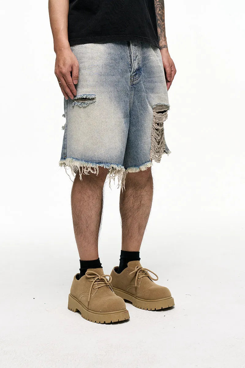 Men's light blue baggy denim shorts with a mid-rise waist and wide leg fit.