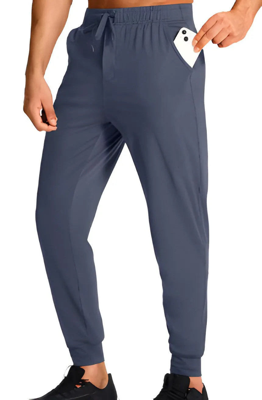 Man wearing loose-fit solid colour casual polyester trousers in a leisure setting.