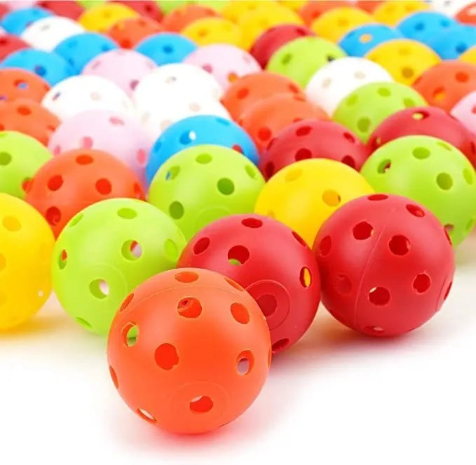 Multi-coloured golf practice balls in net storage pocket for putting training