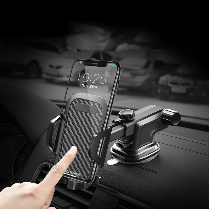 Black universal car phone holder mounted on a car dashboard holding a mobile phone