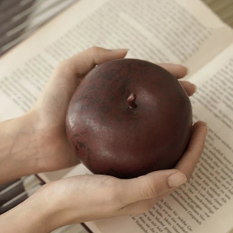 Retro style Chinese ceramic apple decoration ornament on a desktop.