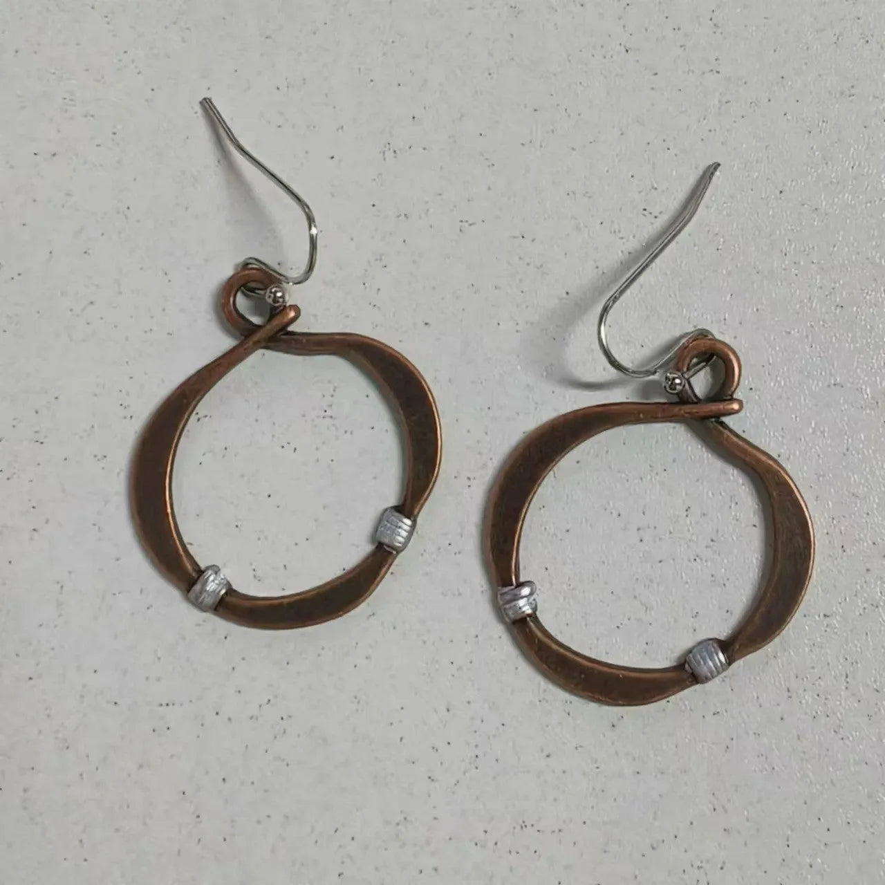 Retro hollow round bohemian earrings with bronze finish cable trim on female ear