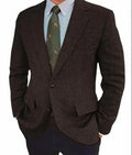 Men's brown herringbone pattern retro suit jacket with long sleeves on a hanger.