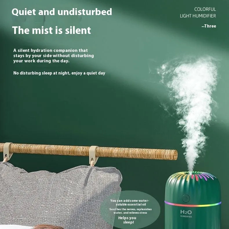 Mini car-shaped USB aromatherapy humidifier in green, pink, or white colours on a desk.
