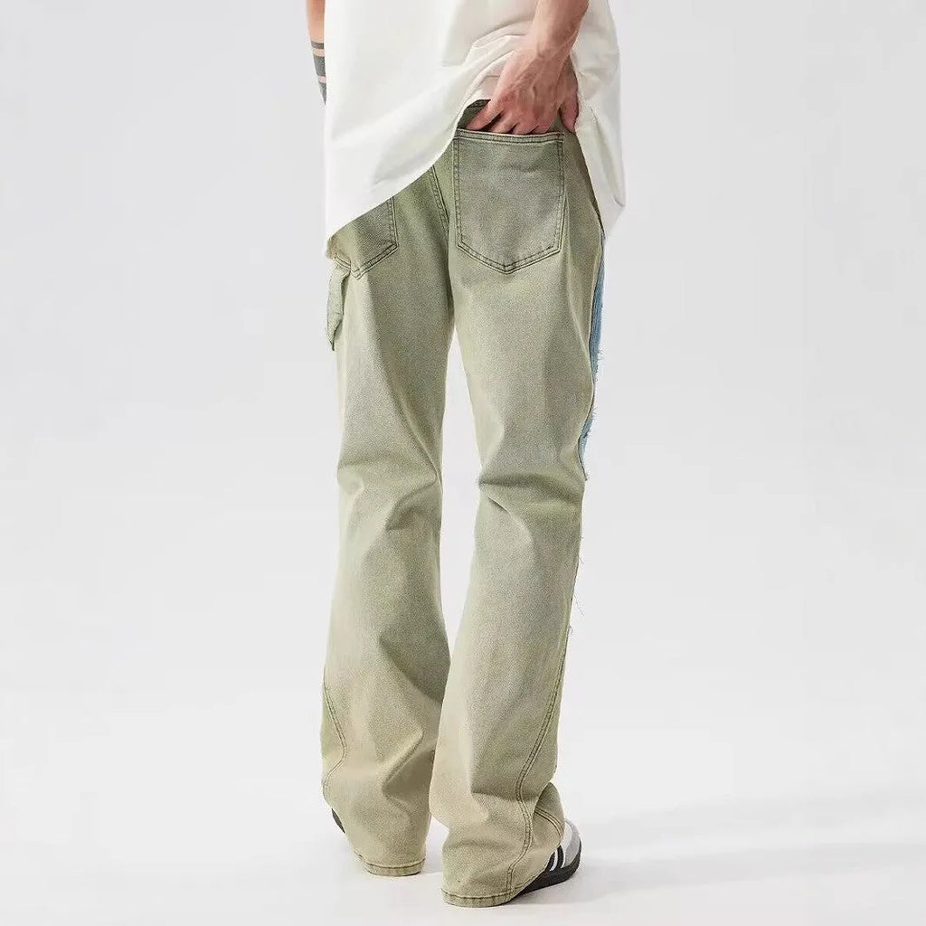 Retro jeans featuring yellow and blue patchwork splash-ink damaged design on non-stretch denim.