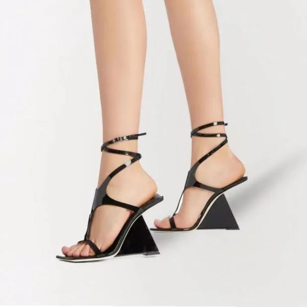 Women's black high heel sandals with a square toe and button fastening on a 9.5cm heel.