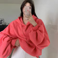 Women's watermelon red sleeveless hooded sweater made from mulberry silk fabric on a hanger